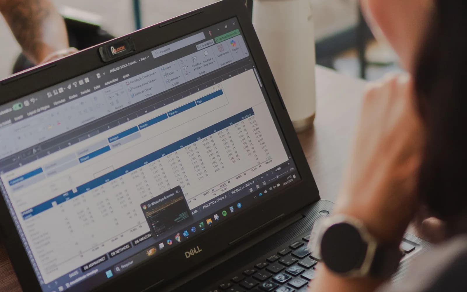 Someone reviewing a data workflow spreadsheet on a laptop, representing operational and reporting automation.